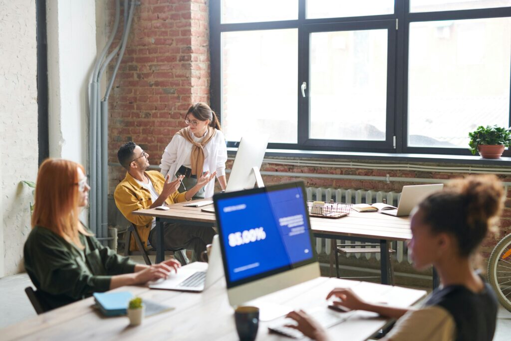 Diverse group of coworkers collaborating in an open office, representing how California insurance plans can integrate Medicare benefits into workplace health discussions.