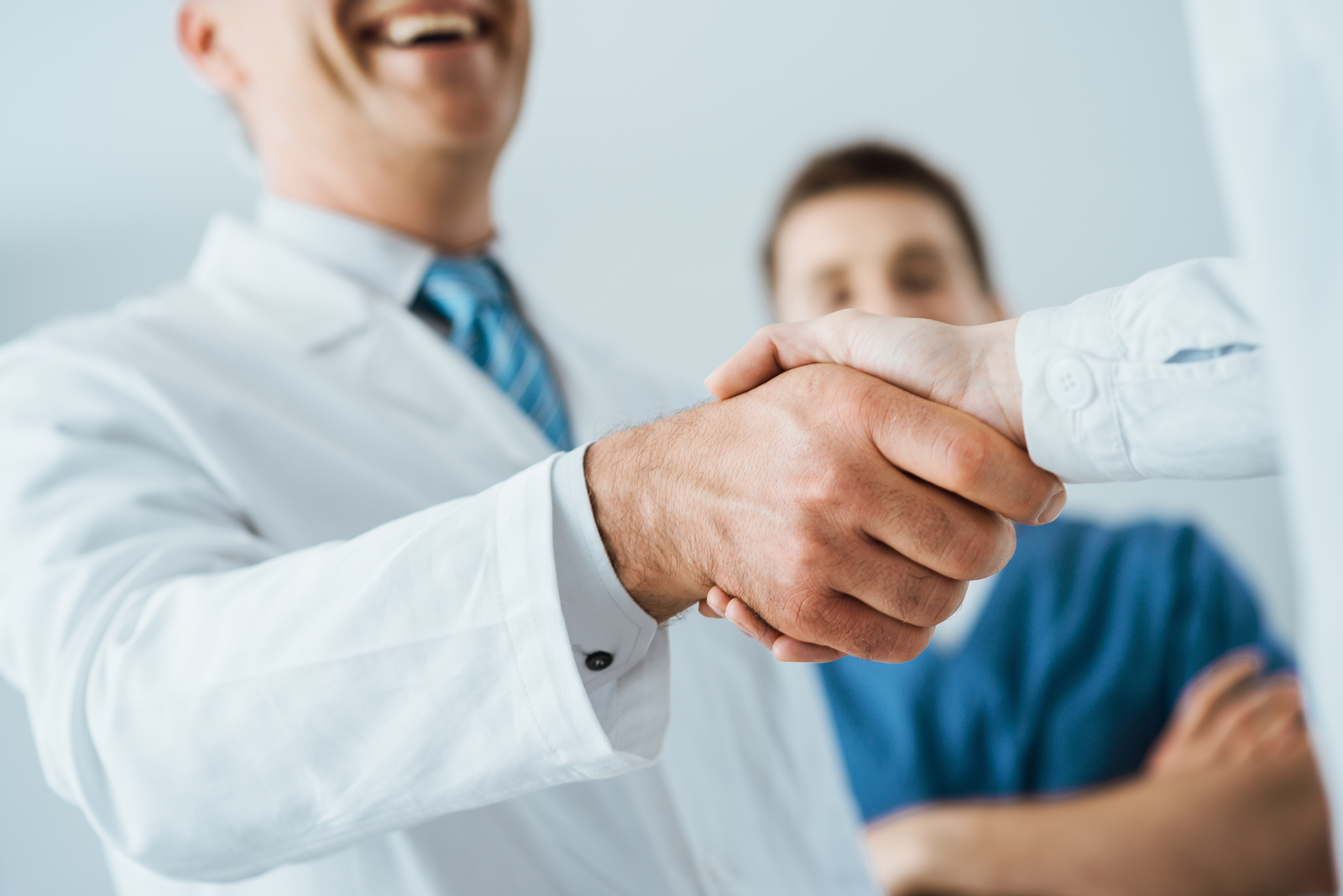 Patient with health plan under Special Enrollment shakes hands with doctor